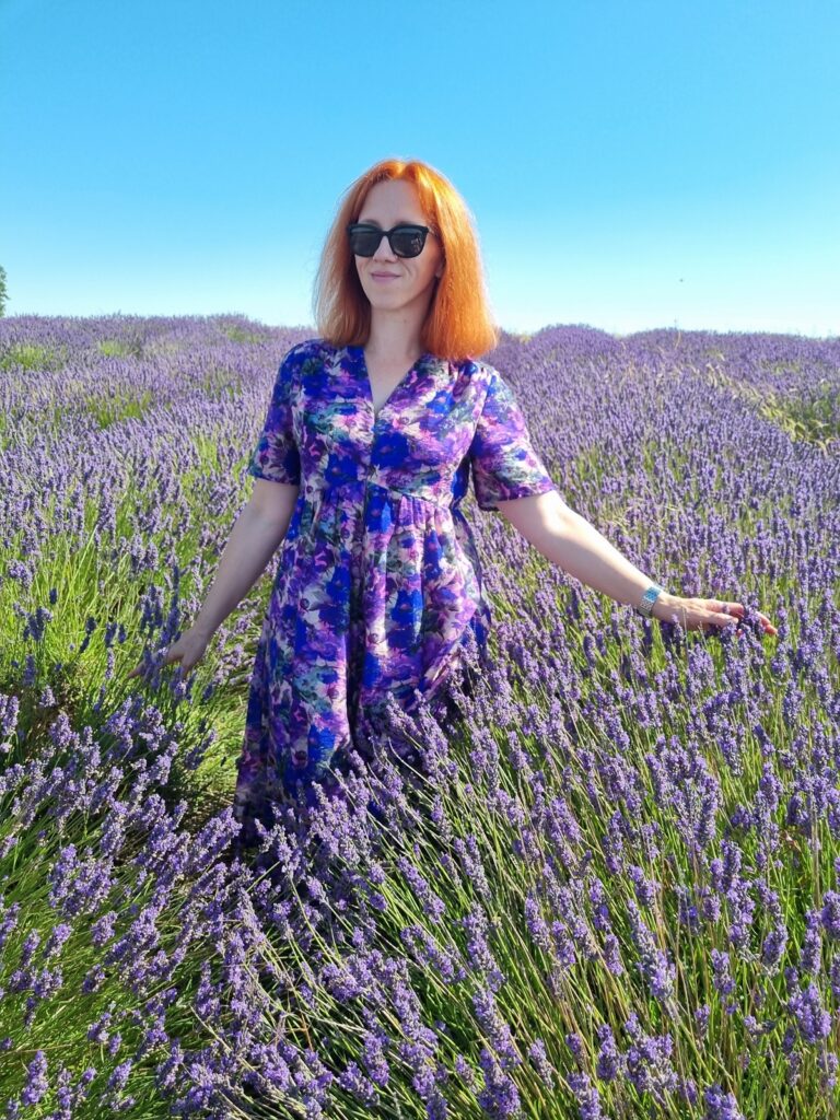FiddlyLily wearing a handmade heather‑print dress in a field of heather